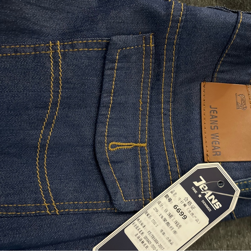 Classic Blue Jeans with Golden Stitching and Leather Patch